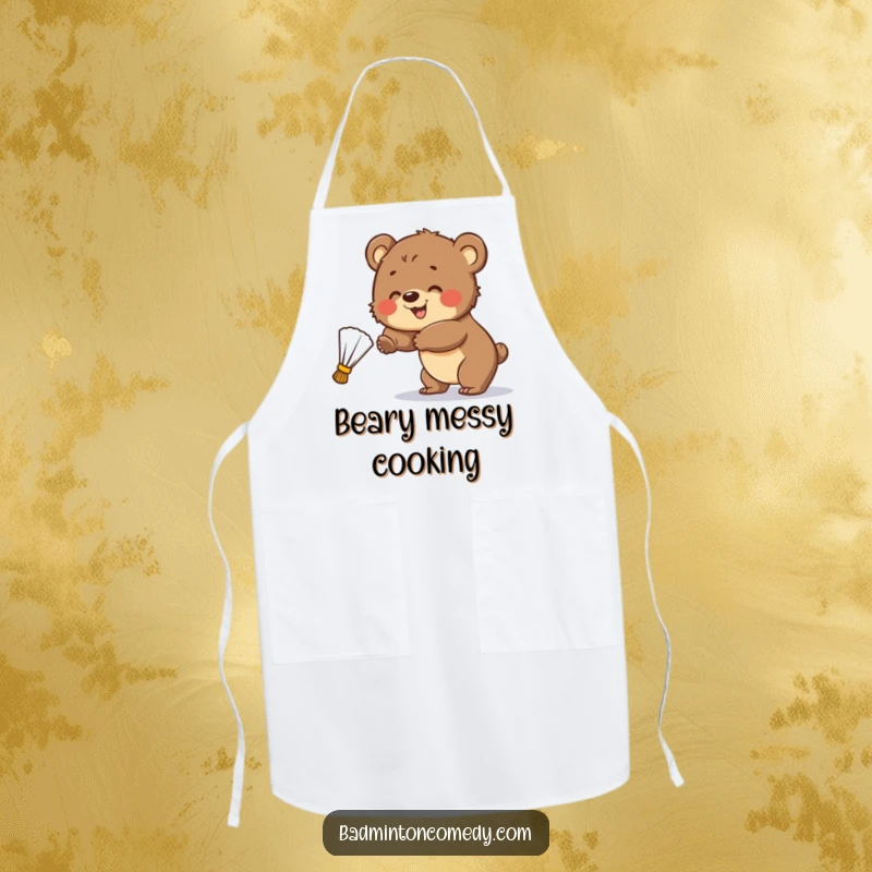 Funny Apron: A smiling bear cub tries to hit a badminton shuttlecock, showcasing playful kitchen action.