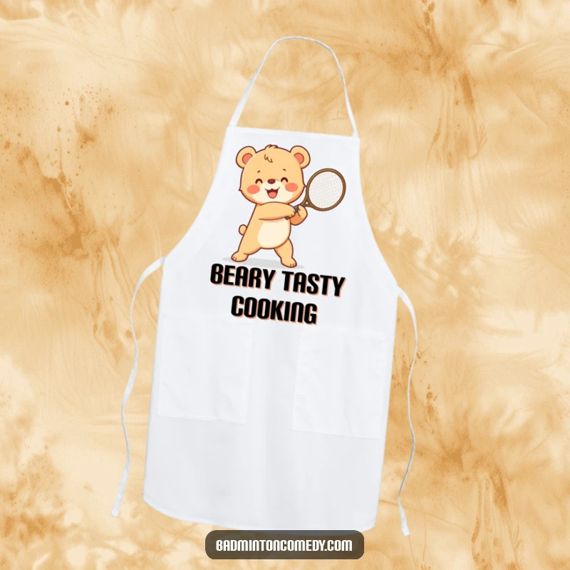 Funny happy bear cub in a winning pose, swinging a tennis racket, a humorous apron for kitchen champions.