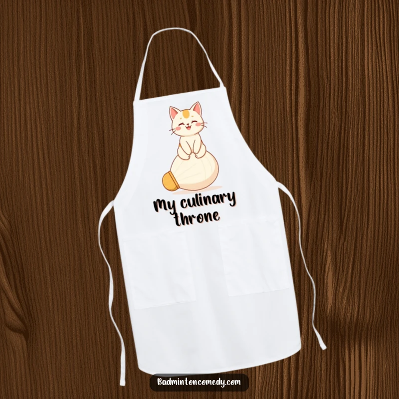 Funny apron with a proud, happy cat character perched atop a giant shuttlecock, ready to supervise kitchen activities.