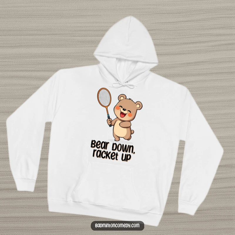 Funny, cheerful bear swinging a large badminton racket, featured on a cozy hoodie, a funny gift.