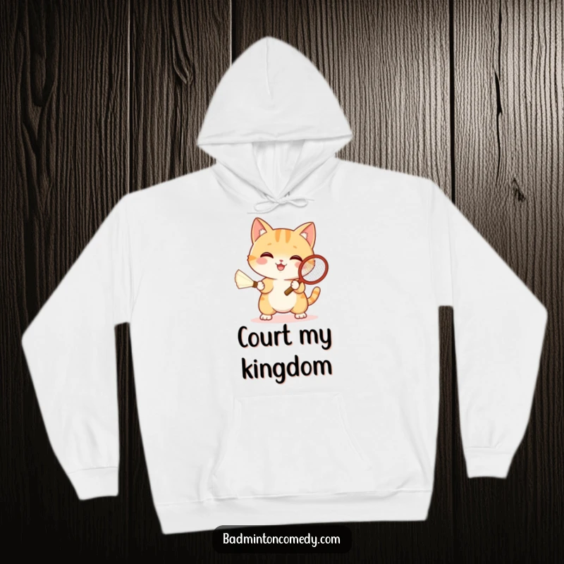 Funny cat in sporty attire, enthusiastically swinging a badminton racket at a shuttlecock, printed on a cozy hoodie.