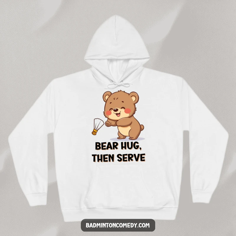 Funny Hoodie: A smiling bear cub attempts to hit a badminton shuttlecock, capturing a moment of endearing sporting effort.