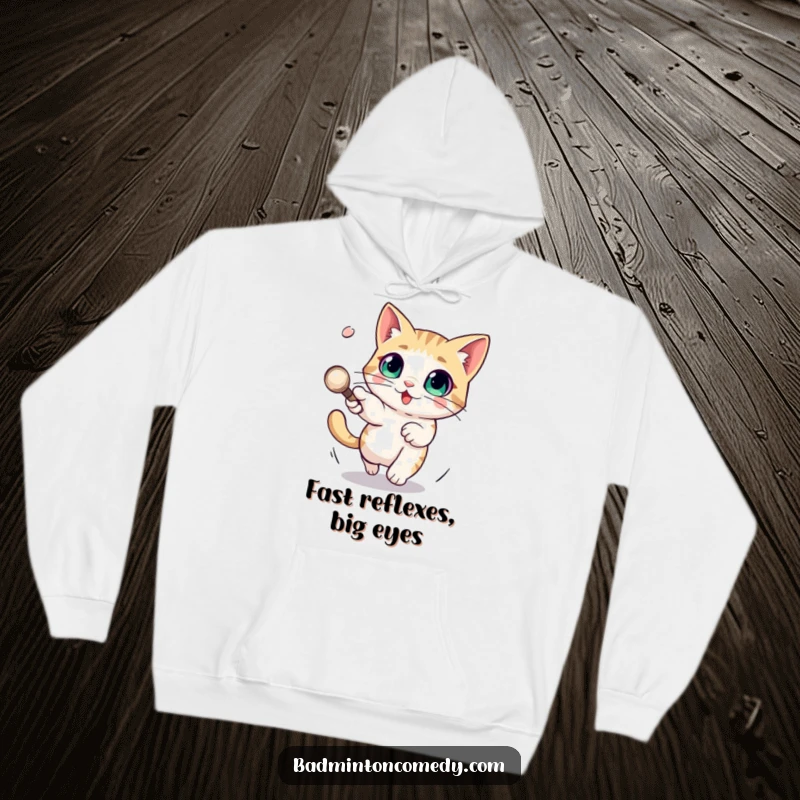 Funny hoodie featuring a cat with large, surprised eyes narrowly missing a swiftly moving shuttlecock in a humorous chase.