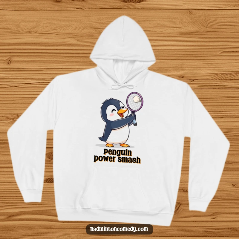 Funny Penguin Badminton Hoodie: A penguin character lunges fiercely, racket held high, preparing to hit a shuttlecock with determination.