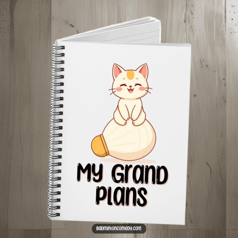 Funny notebook featuring a happy cat sitting proudly on a giant shuttlecock, ideal for jotting down victorious ideas.