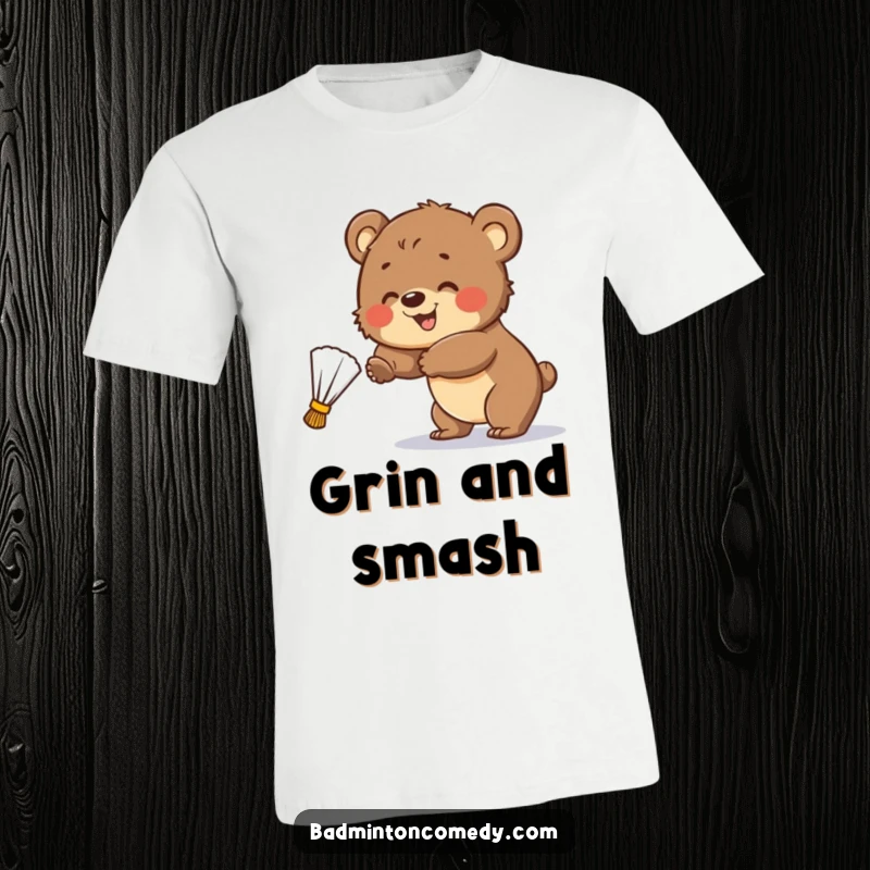 Funny T-Shirt: A happy bear cub swings at a badminton shuttlecock, demonstrating playful determination and a sense of fun.