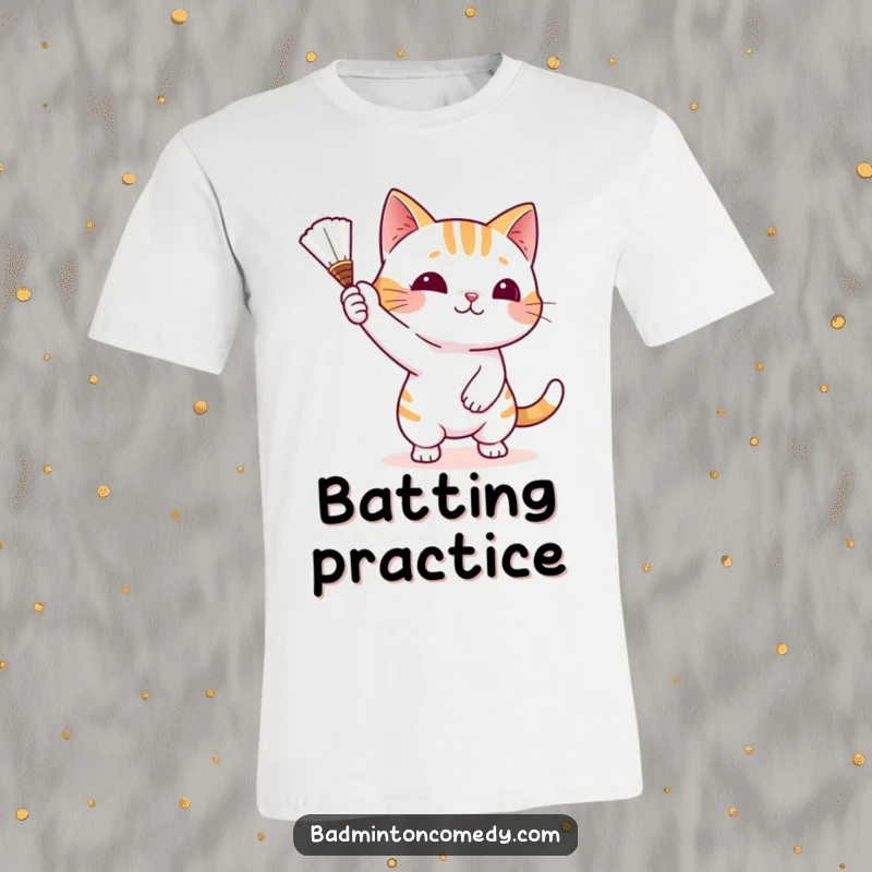 Funny Cat Badminton T-Shirt showing a mischievous cat batting a shuttlecock with its paw, capturing playful intensity.