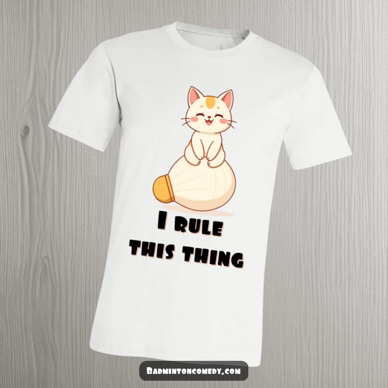 Funny t-shirt with a happy cat character sitting triumphantly on a giant shuttlecock, wearing a proud and satisfied expression.