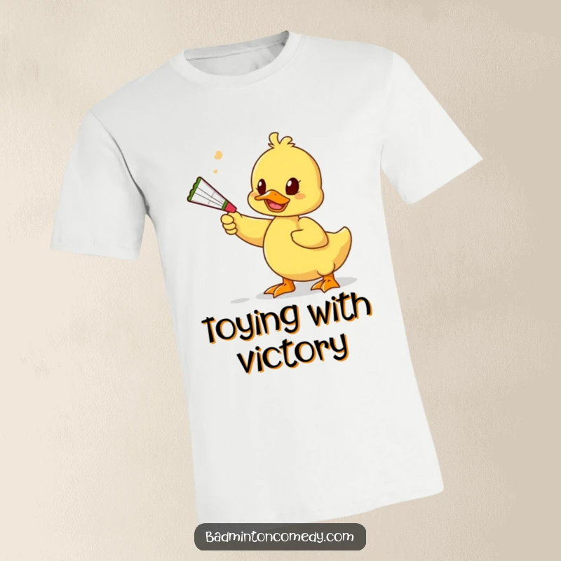 Funny Duck Toy T-Shirt: A silly duck uses a squeaky toy as a racket to playfully hit a shuttlecock, emphasizing fun.