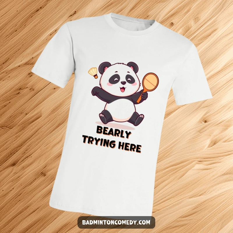 Funny panda t-shirt, a playful bear comically pursuing a shuttlecock with a tennis racket, capturing a moment of hilarious sporting pursuit.