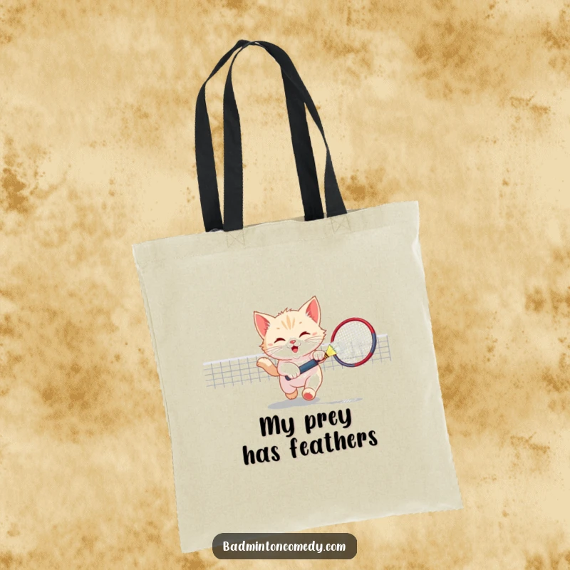 Funny Kitten Badminton Tote Bag: A playful kitten chasing a shuttlecock, perfect for carrying daily items with a humorous theme.