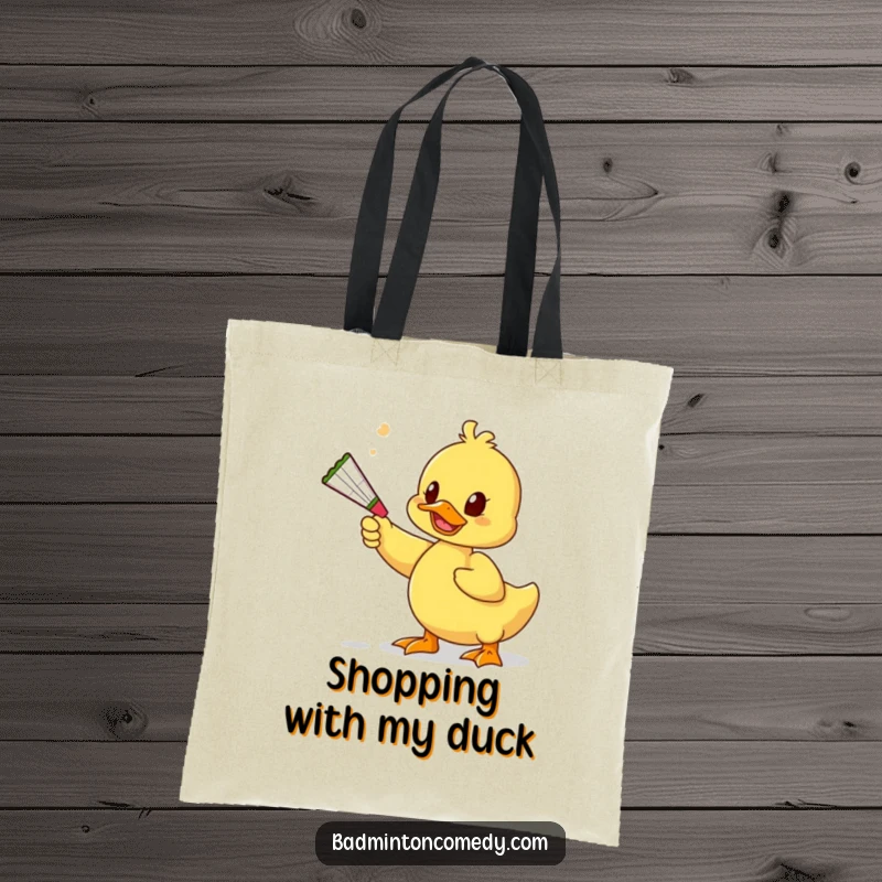 Funny Duck Toy Tote Bag: A humorous duck uses a squeaky toy to playfully bat a shuttlecock, perfect for everyday use.